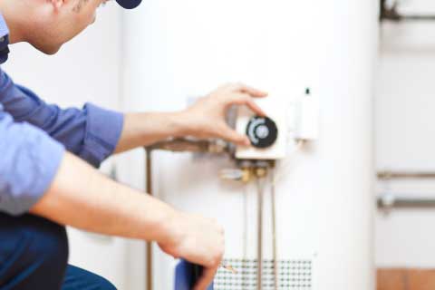Service Guy Reviewing Water Heater